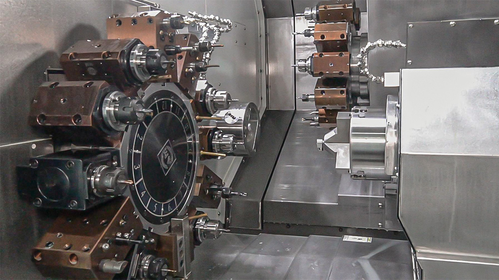 Dual-spindle dual-turret CNC machining center handling a complex metal part