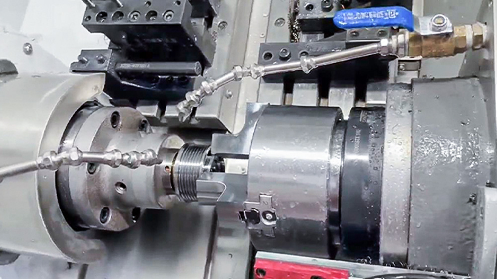 Dual-spindle CNC lathe automatic part transfer for complete machining